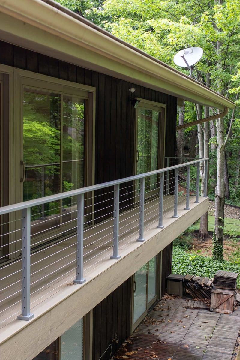 arola custom deck corner view dark  wood siding windows