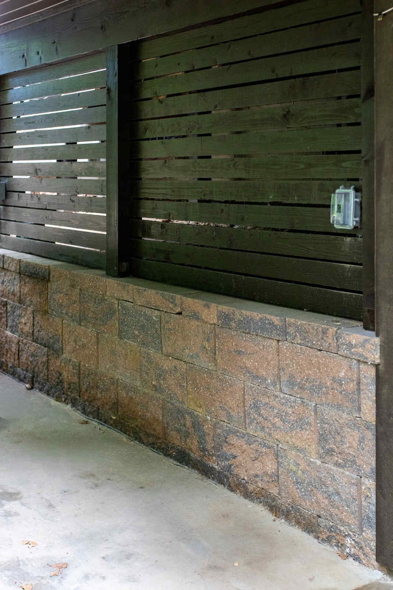 arola custom deck wood slat wall over stone base
