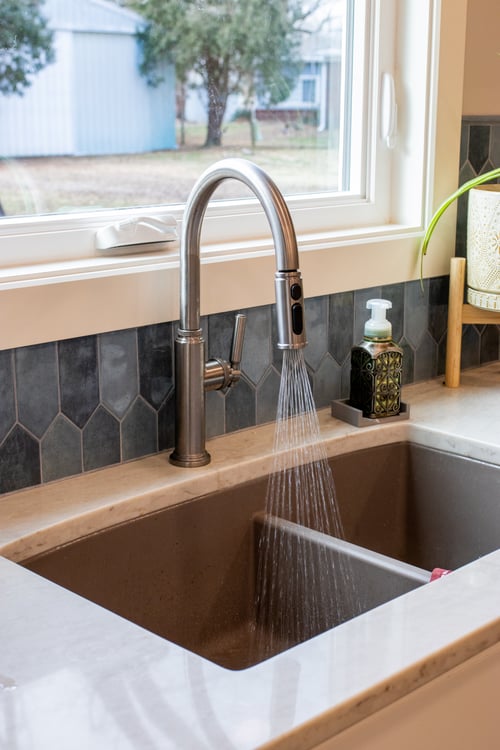 Kitchen remodel sink closeup with blue tile backsplash