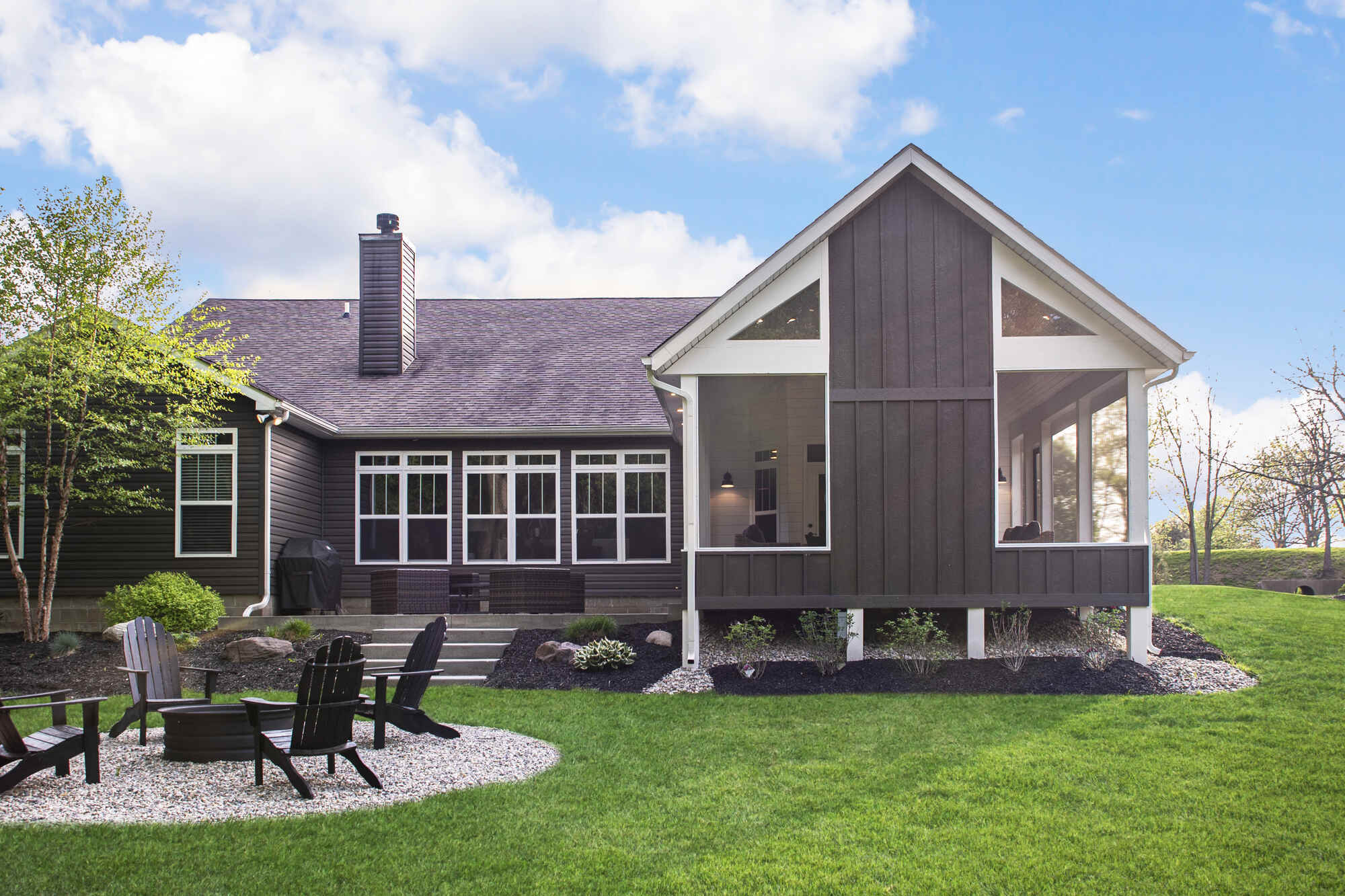Charming screened porch with vaulted gable roof and open seating area, designed by S. Brown Construction Co. in Buck Creek, IN.