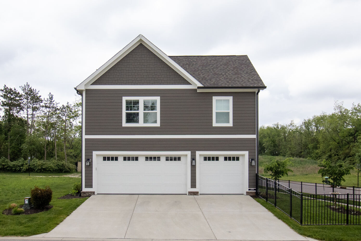 Rear view of a custom-built three-car garage home by S. Brown Construction Co. in University Farm, IN.