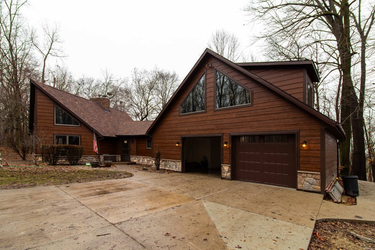Wood and stone custom home exterior with angled roof by S. Brown Construction Co. in Raineybrook, IN.