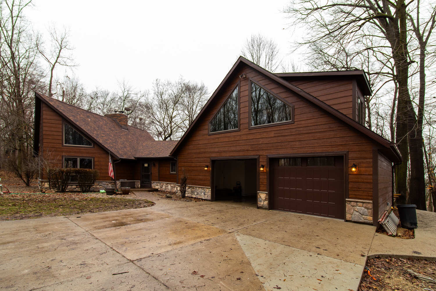 Wood and stone custom home exterior with angled roof by S. Brown Construction Co. in Raineybrook, IN.