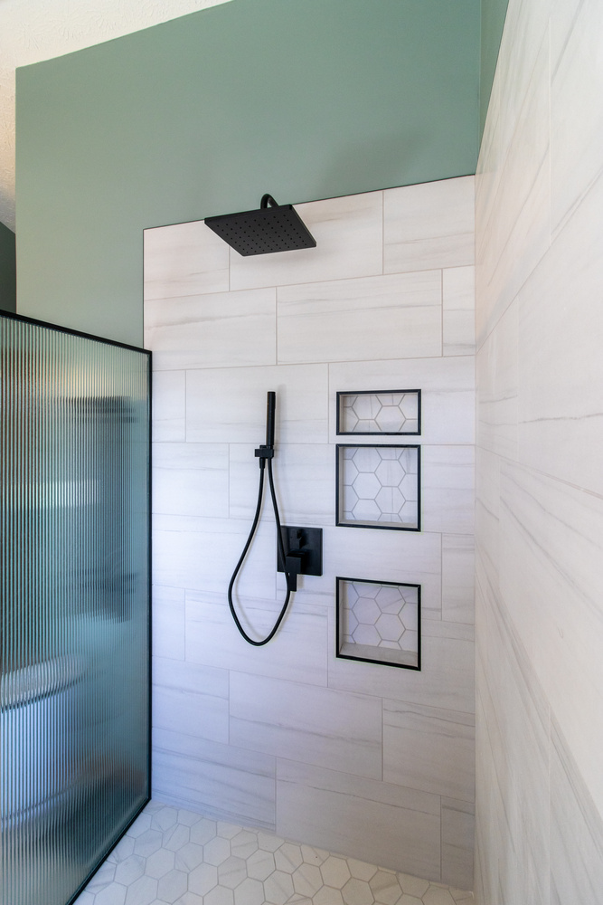 Clean and modern walk-in shower with geometric tile accents in Wildcat Creek, IN by S. Brown Construction Co.