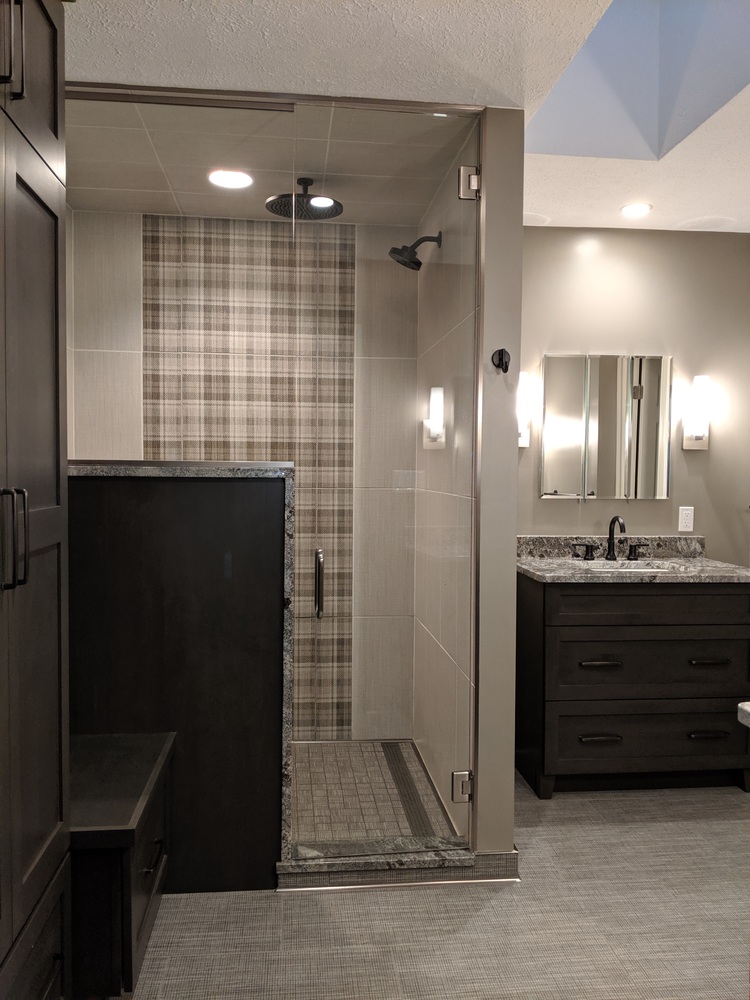 Modern bathroom remodel featuring walk-in shower with plaid accent tile by S. Brown Construction Co. in West Lafayette, IN.