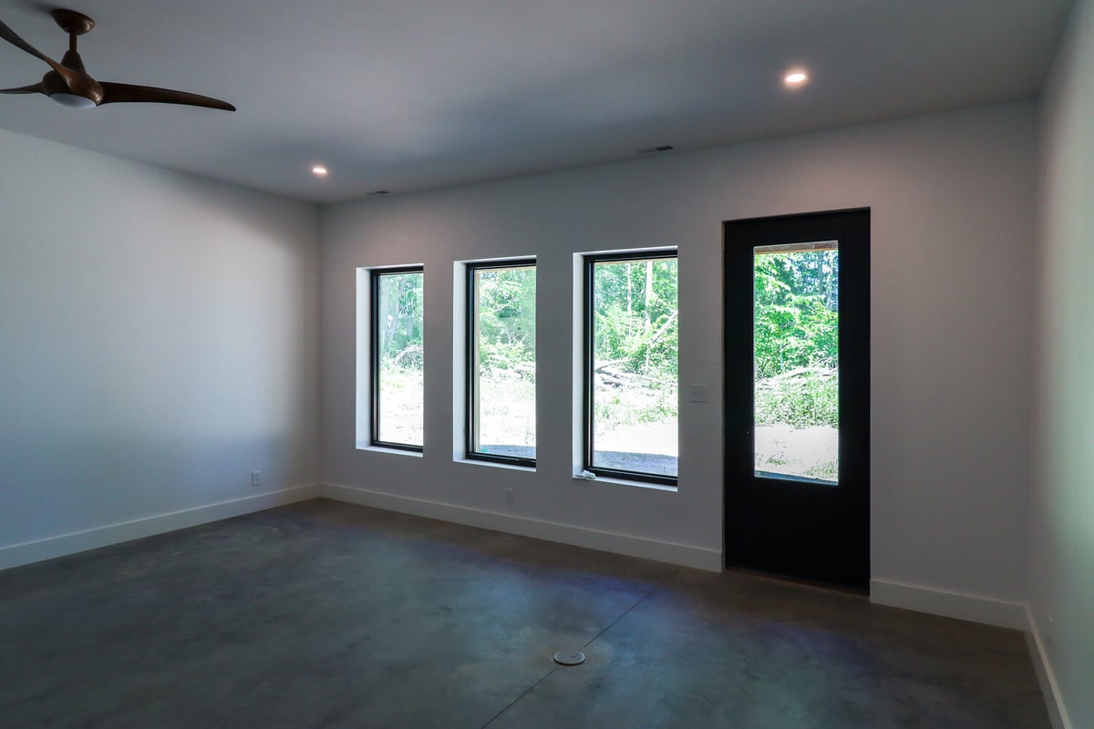 Simple and bright barndo interior with large windows and concrete floors by S. Brown Construction Co. in Bar Barry Heights, IN.