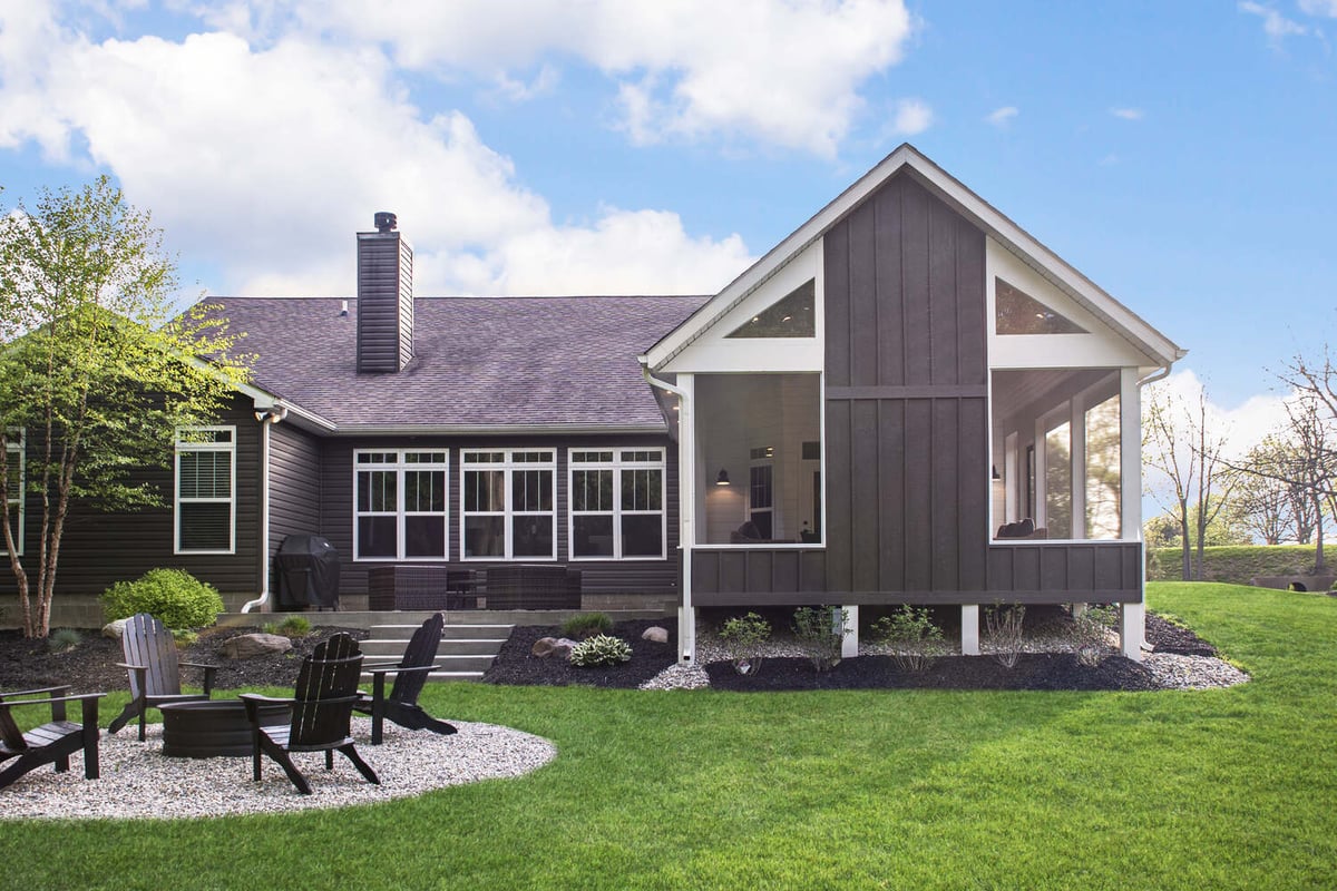 Charming screened porch with vaulted gable roof and open seating area, designed by S. Brown Construction Co. in Buck Creek, IN.