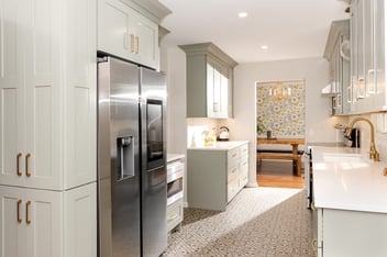 Elegant galley kitchen remodel with gold hardware and patterned flooring by S. Brown Construction Co. in Lafayette, IN.