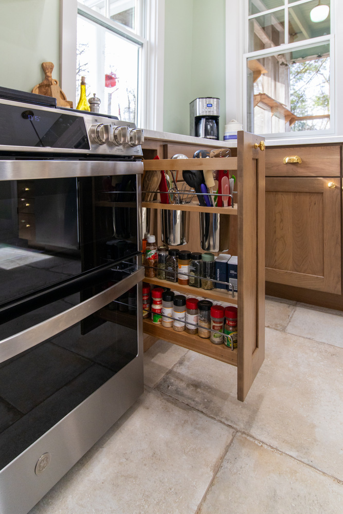 Pull-out spice and utensil storage installed in custom kitchen by S. Brown Construction Co. in Wildcat Creek, IN.