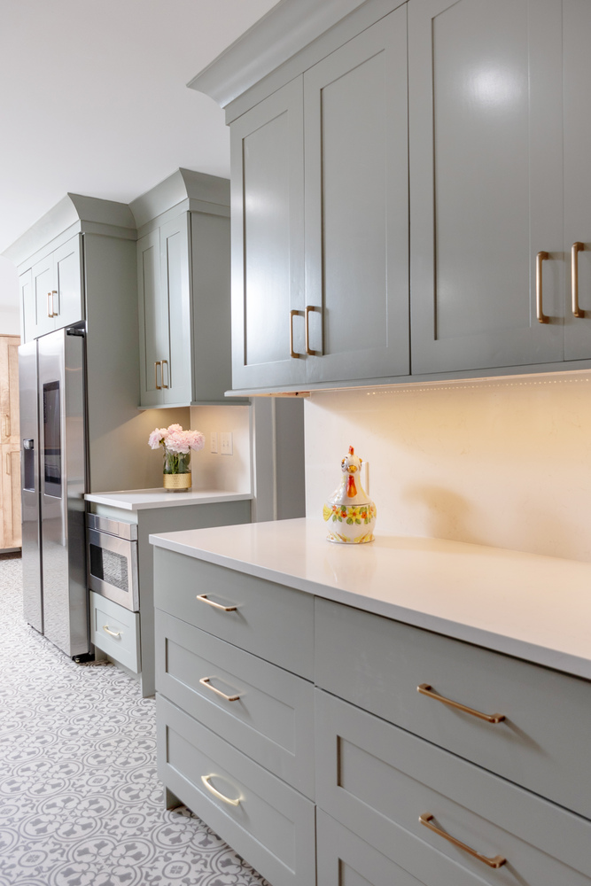 Soft green cabinetry with quartz countertops in Wildcat Creek, IN kitchen remodel by S. Brown Construction Co.