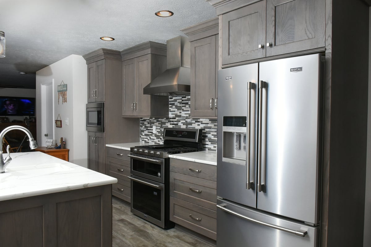 Updated custom kitchen in Buck Creek, IN featuring stainless appliances and gray cabinets by S. Brown Construction Co.