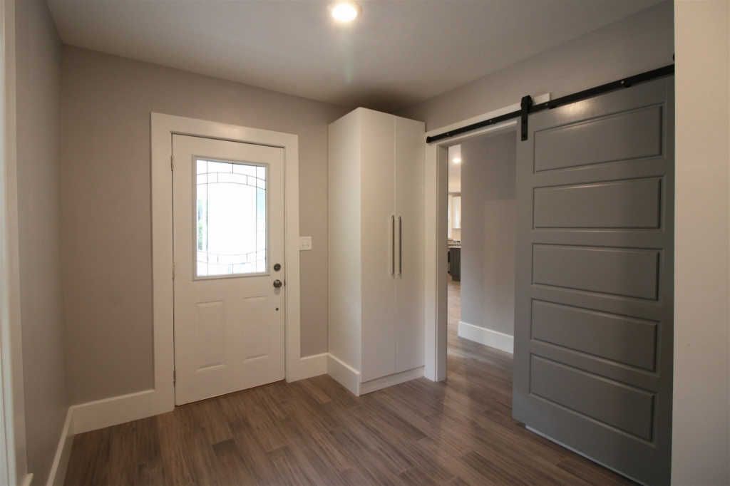 Entryway remodel with sliding barn door and custom cabinetry by S. Brown Construction Co. in University Farm, IN.