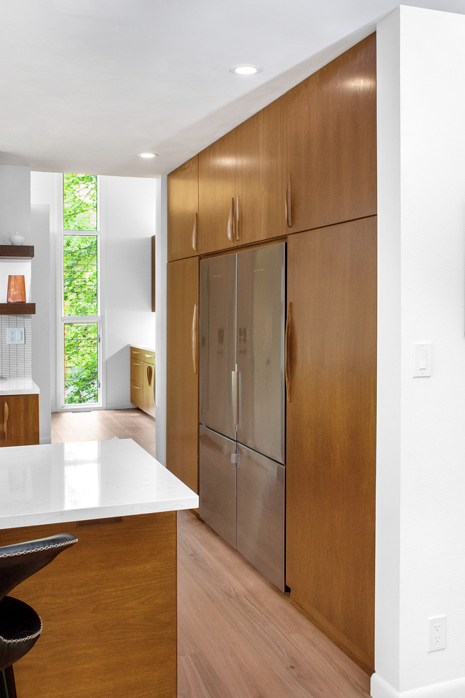 Integrated refrigerator and floor-to-ceiling custom cabinetry by S. Brown Construction Co. in Lafayette, IN.