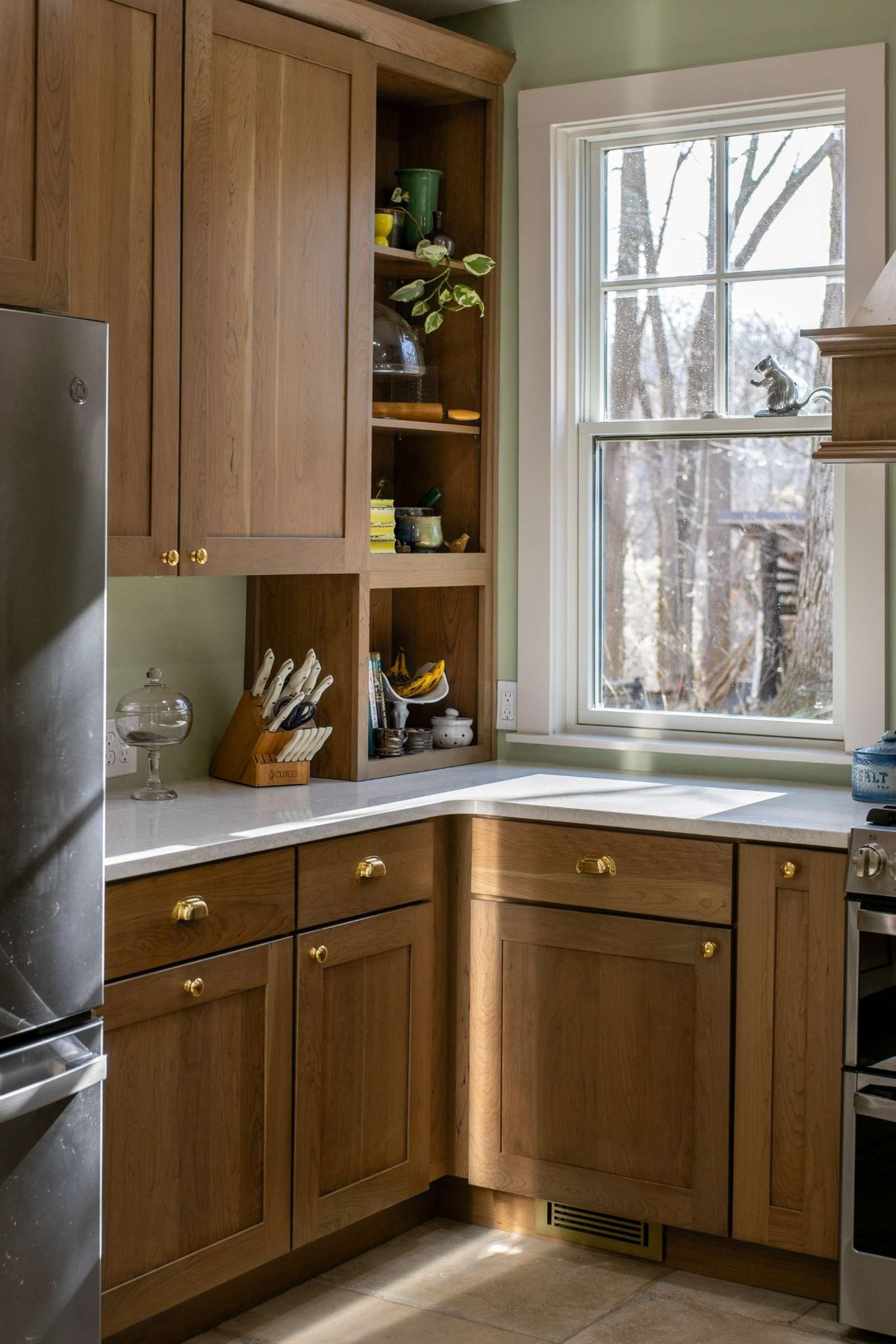 Corner kitchen cabinetry with open shelving and natural light in Lafayette, IN remodel by S. Brown Construction Co.
