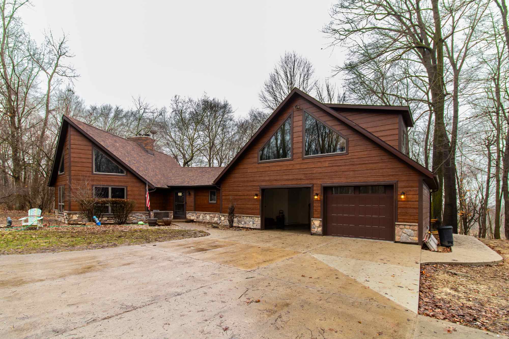 Expanded view of the Schoon Garage Addition featuring stained wood siding and stone accents by S. Brown Construction Co. in Lafa-optimized