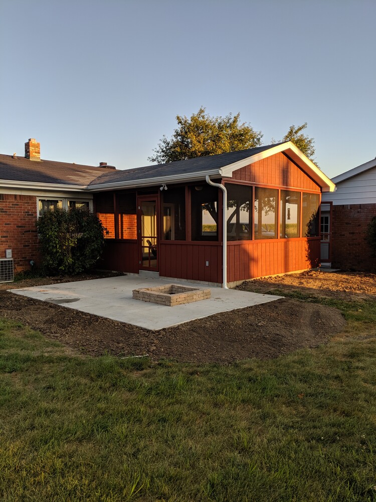 Rear view of a home featuring a red screen porch addition in Lafayette, IN by S. Brown Construction Co.