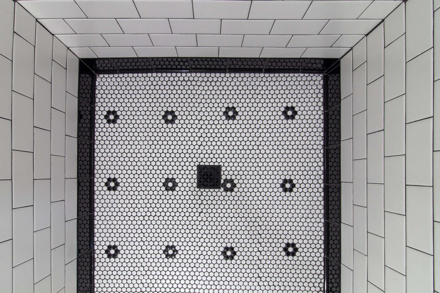 Overhead view of hexagon mosaic tile floor in custom shower by S. Brown Construction Co. in Wildcat Creek, IN.