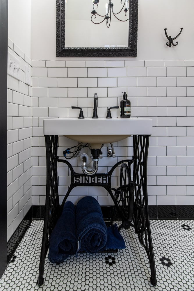 Vintage-style vanity with exposed Singer sewing machine base by S. Brown Construction Co. in Arbor Chase, IN.