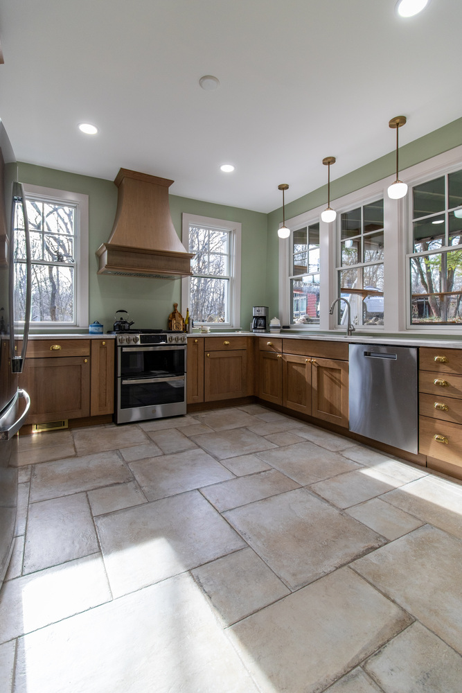 S. Brown Construction Co. kitchen renovation in University Farm, IN with stainless appliances and sage green walls.