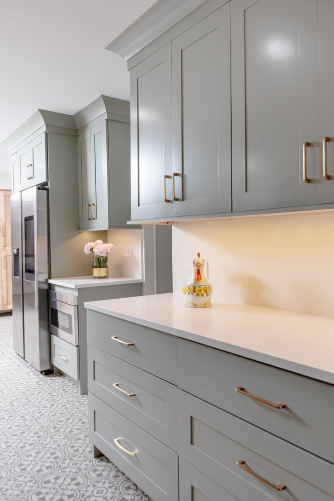 Soft green cabinetry with quartz countertops in Wildcat Creek, IN kitchen remodel by S. Brown Construction Co.