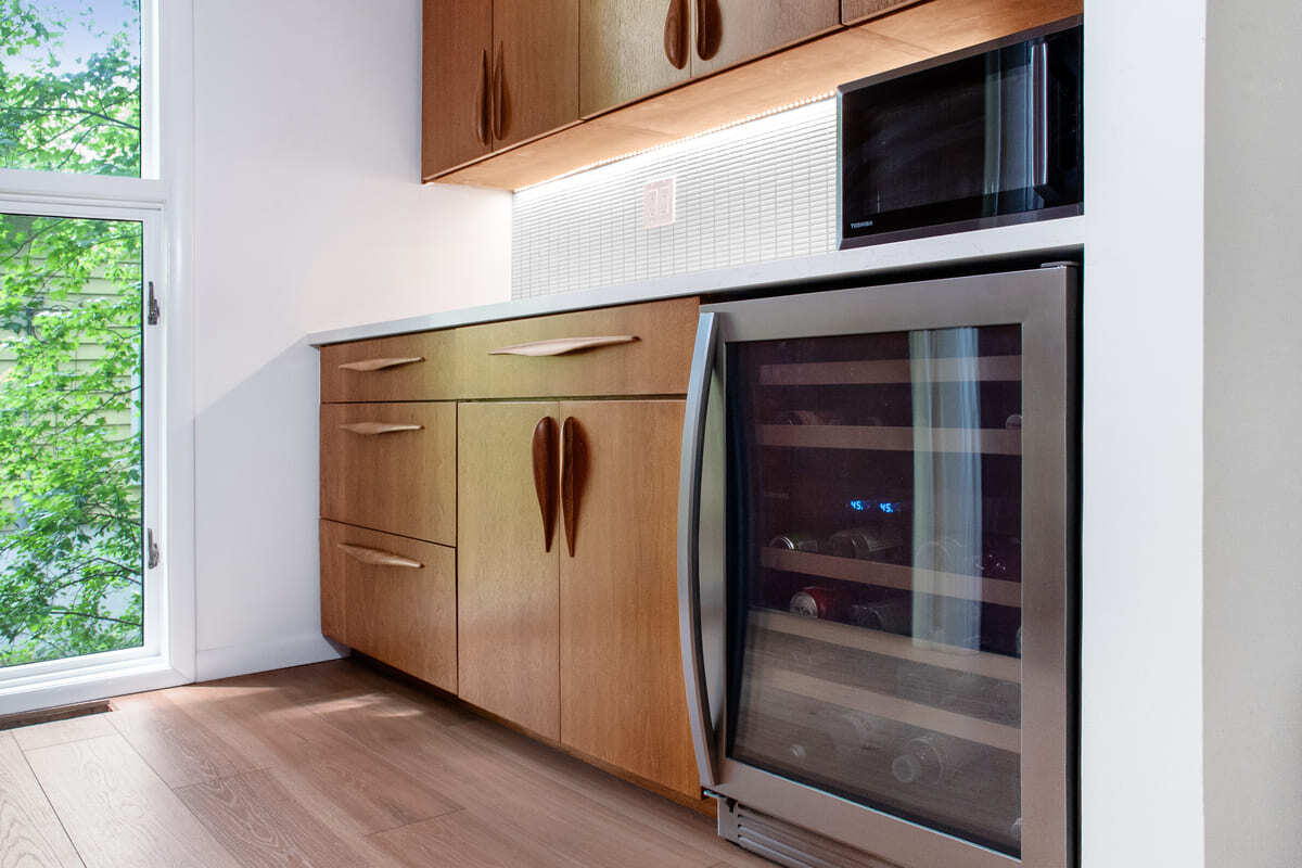 Beverage station in kitchen remodel in Lafayette with custom cabinets, wine fridge, and custom lighting