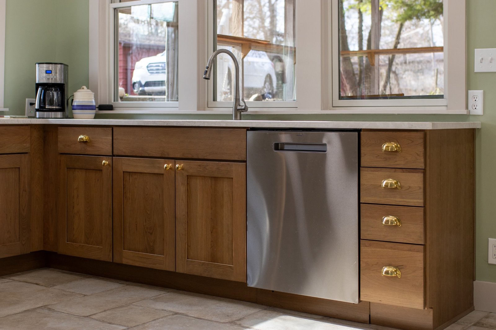 Kitchen sink area with dishwasher and wood cabinets in Lafayette, IN by S. Brown Construction Co.