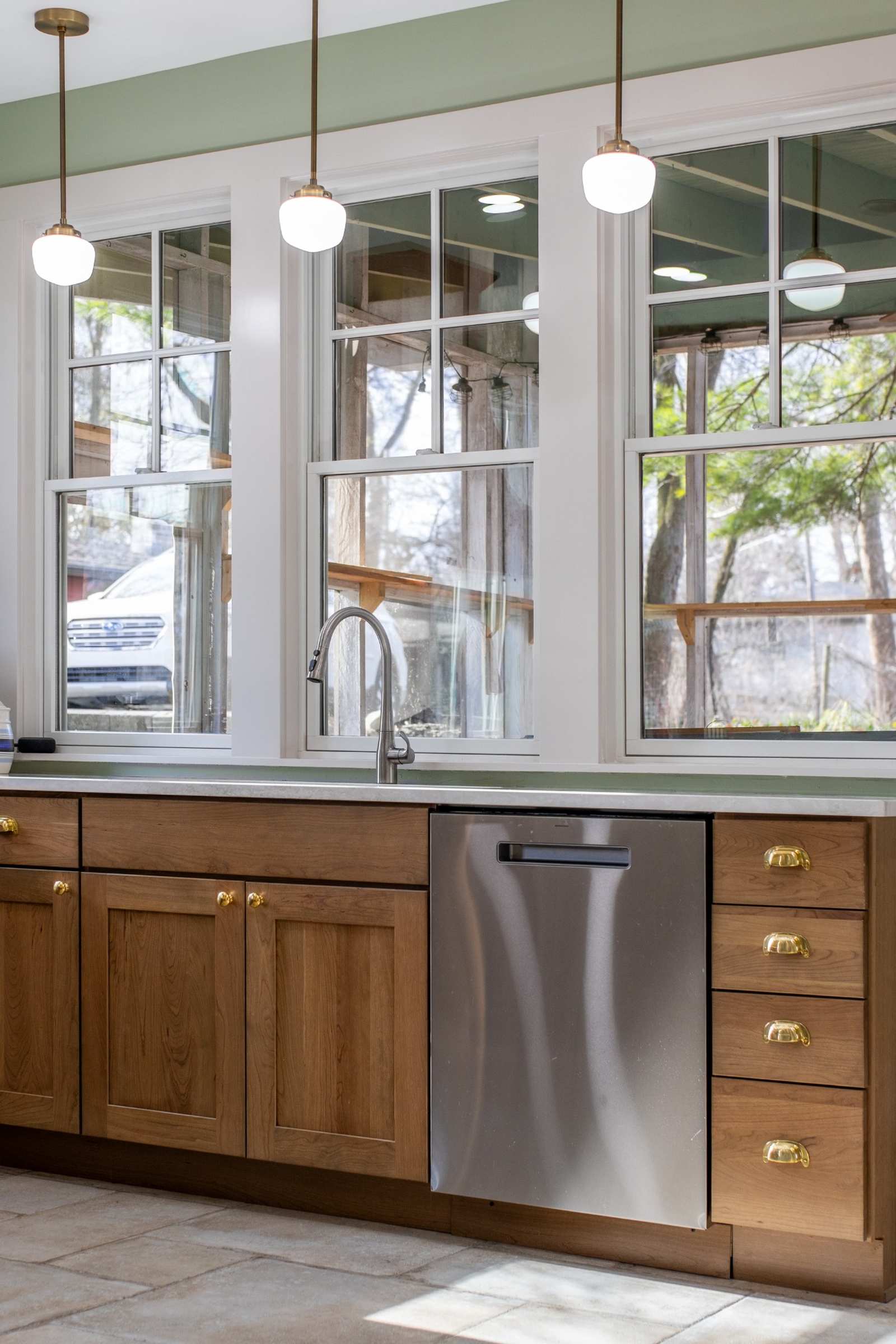 Kitchen sink wall with pendant lighting and wood cabinetry in Lafayette, IN by S. Brown Construction Co.