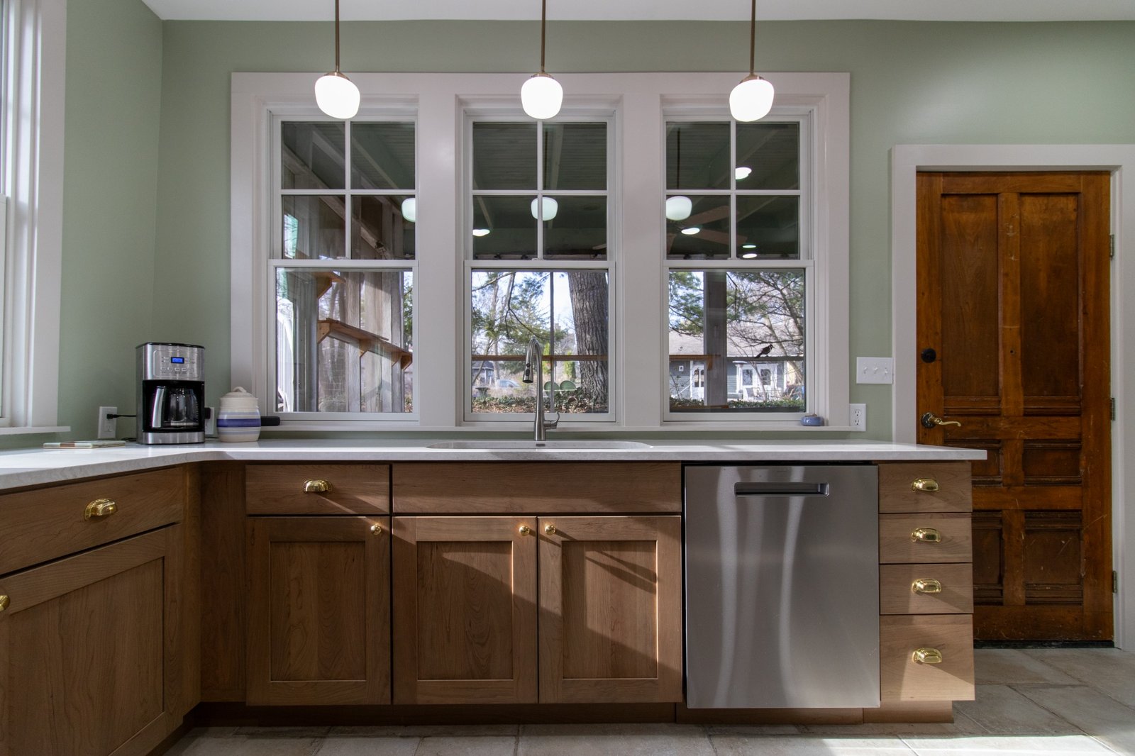 kitchen island sink with triple windows and pendant lighting by S. Brown Construction Co. in Lafayette IN