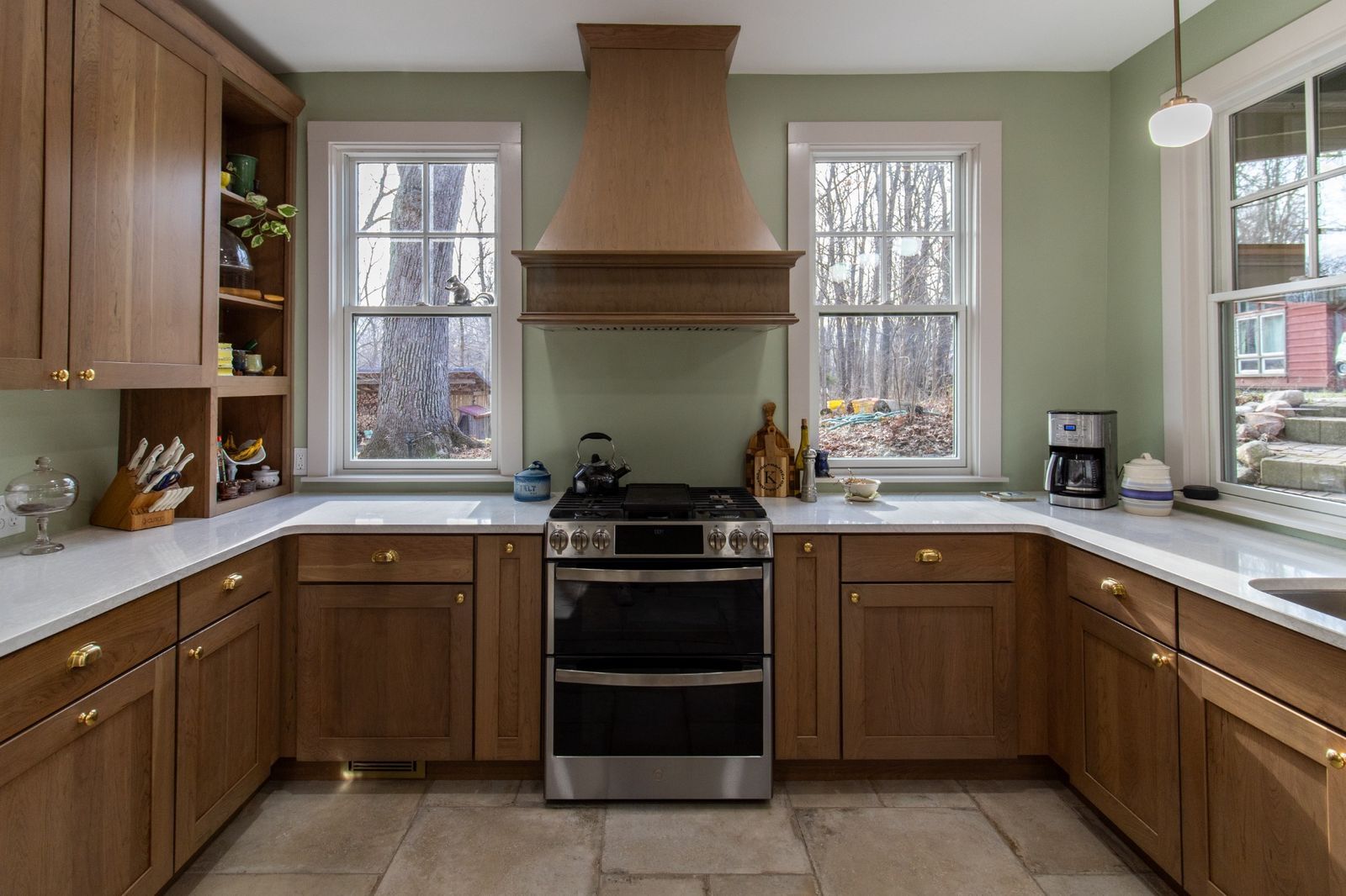 kitchen range and hood with wood cabinetry and windows by S. Brown Construction Co. in Lafayette IN