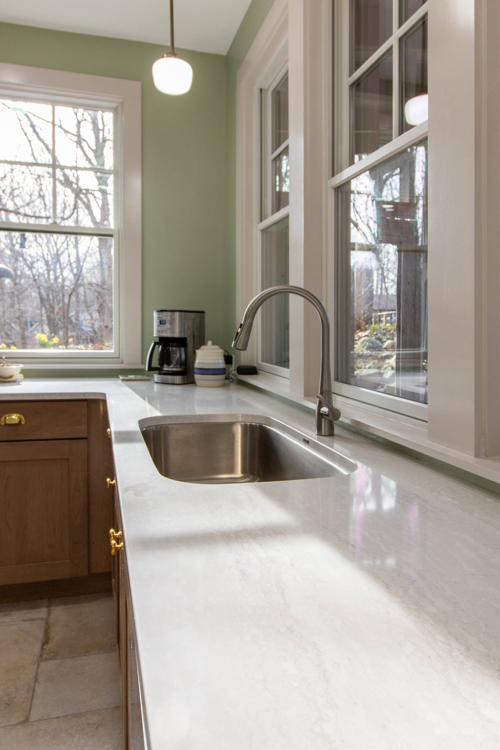 kitchen sink with quartz countertop and window lighting by S. Brown Construction Co. in Lafayette IN remodel
