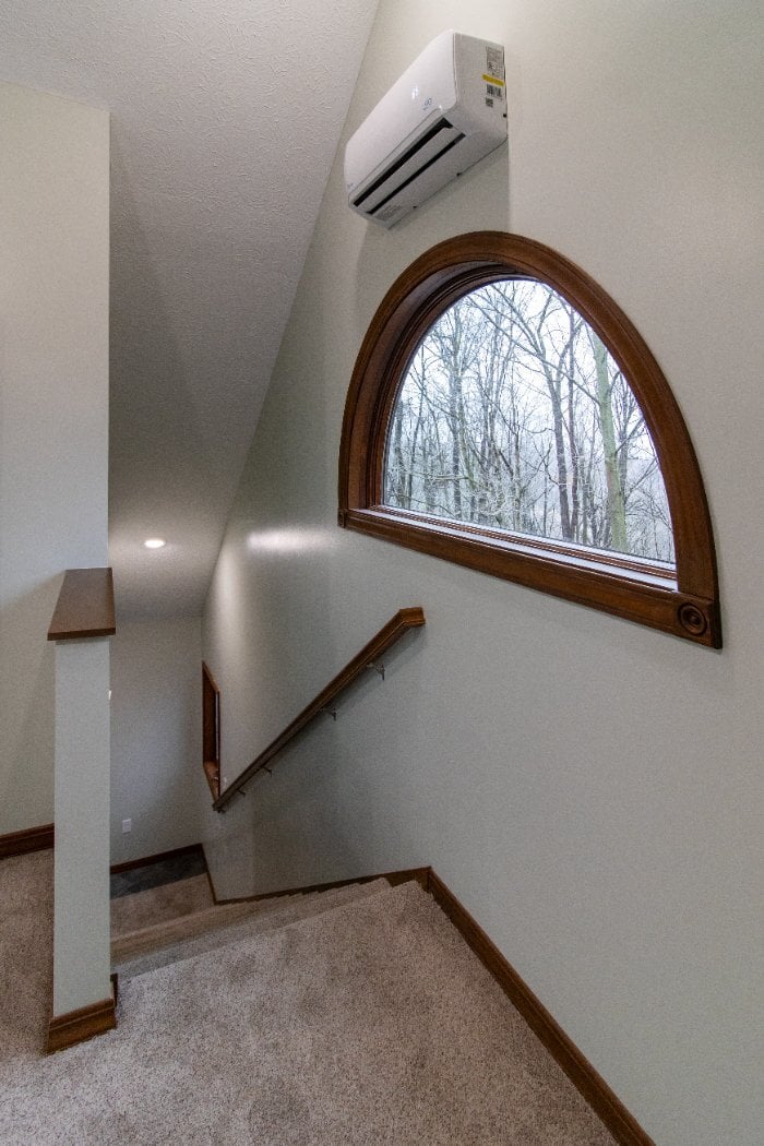 S. Brown Construction Co. Schoon Garage Addition stairway with arched window, wood trim, and natural daylight in Lafayette, IN.-optimized